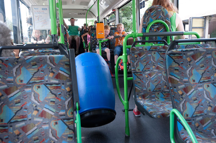 Eine blaue Tonne fliegt durch den Bus.